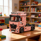 Side view of the Knew Built pink truck building block toy highlighting its length.